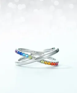 Macro shot of S925 silver double-cross ring featuring colorful rainbow cubic zirconia