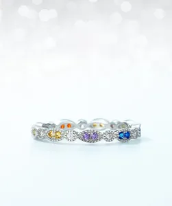 Macro shot of S925 silver eternity ring featuring vibrant rainbow marquise-cut cubic zirconia