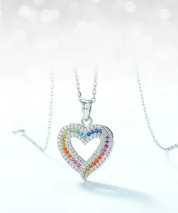 Close-up of S925 silver heart pendant featuring rainbow cubic zirconia pavé stones