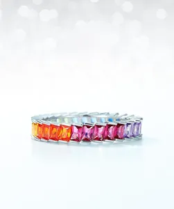 Close-up of S925 silver eternity ring with channel-set rainbow baguette cubic zirconia