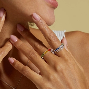 Elegant S925 silver rainbow zircon stacked rings set worn by a model in a warm setting