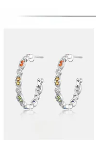 Macro shot of S925 silver C-shape earrings with rainbow cubic zirconia pavé stones