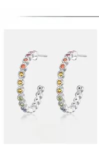 Detail of C-shaped S925 silver hoop earrings with rainbow pavé zircon stones