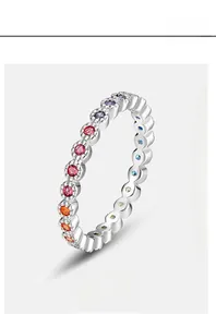 Macro shot of silver ring with rainbow cubic zirconia pave setting and polished metal finish