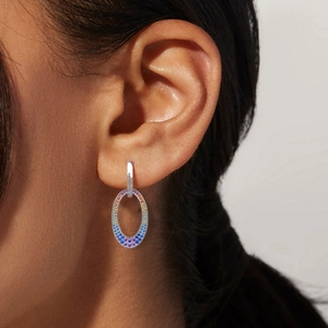 Macro detail of S925 silver earrings featuring vibrant rainbow pavé zircon gemstones