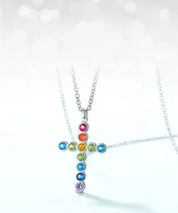 Macro shot of S925 silver cross pendant necklace with vibrant rainbow colored cubic zirconia