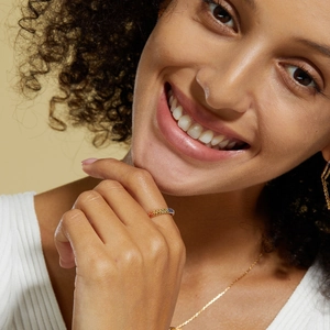 Close-up of a S925 silver 10K gold ring with multi-color cubic zirconia gradient stones