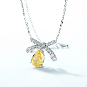 Bowknot S925 silver necklace featuring a pear-cut yellow gemstone and zircon pavé