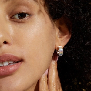 S925 sterling silver hoop earrings with four rows of rainbow pave cubic zirconia on model