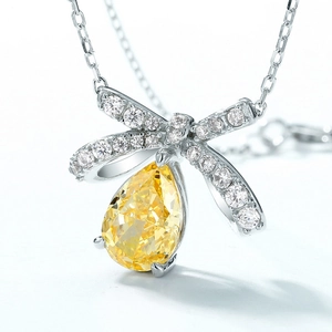 Elegant bow pendant necklace with pear-cut yellow gemstone and S925 silver finish