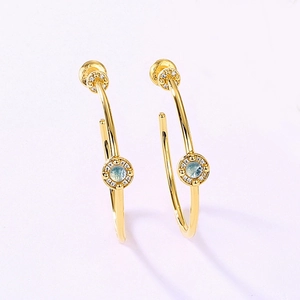 Gold plated large hoop earrings with light blue round gemstones and zircon accents
