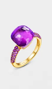 Macro view of gold S925 ring with square purple gemstone and pavé side stones