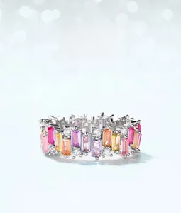 Close-up of rainbow ring featuring rectangular colorful cubic zirconia on silver band