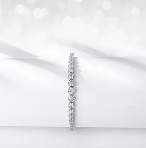 Macro detail of bezel-set moissanite stones on a minimalist silver bracelet band