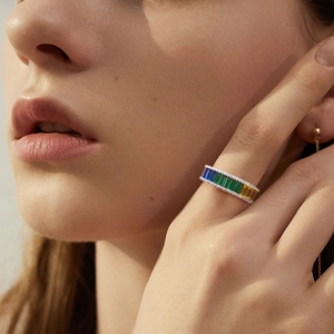 Rainbow baguette-cut zircon eternity ring in silver finish worn on finger