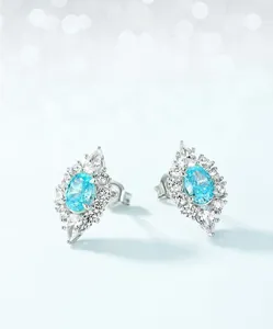 Close-up of S925 silver stud earrings with light blue oval-cut high carbon diamond