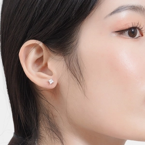 Minimalist S925 sterling silver square zircon stud earring worn on model's ear