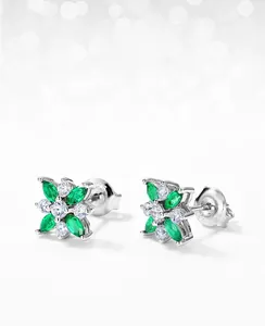 Macro view of clover stud earrings with marquise emerald stones and zircon accents