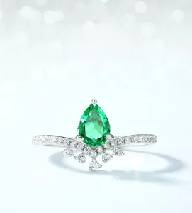 Macro shot of S925 silver crown ring with pear-cut emerald green high carbon diamond