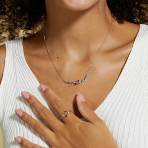 Detail of S925 silver rainbow gemstone necklace and adjustable ring set on model