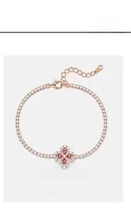Macro shot of rose gold clover bracelet with pink gems and sparkling white diamonds