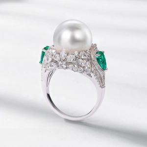 Luxurious S925 silver ring featuring a large white pearl and emerald green side stones