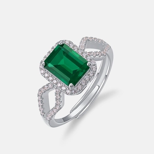 Octagon emerald cut green gemstone ring with pavé halo and silver adjustable band