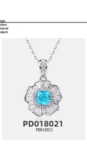 Macro detail of silver flower pendant with blue main stone and high-carbon diamonds