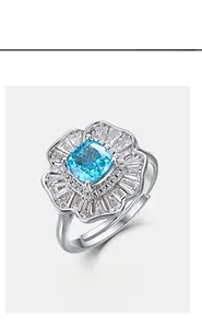 Macro detail of S925 silver flower ring featuring blue radiant cut stone and white zircon