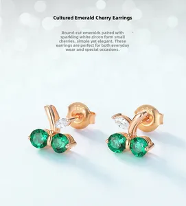 Close-up of S925 silver cherry earrings with emerald green and white zircon stones
