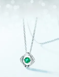 Detail of S925 silver necklace featuring a geometric emerald and white zircon pendant