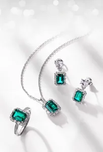 Close-up of S925 silver jewelry set featuring emerald-cut lab-grown green emeralds