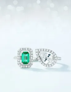 Macro detail of S925 silver ring featuring emerald cut green stone and teardrop zirconia
