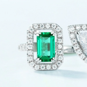 S925 silver open ring featuring an emerald-cut green stone with halo setting