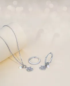 Macro shot of S925 silver snowflake jewelry set with white pearls and sparkling zircons