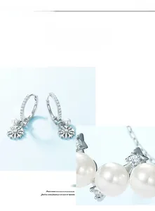 Macro shot of S925 silver snowflake earrings with round pearls and sparkling zirconia