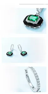 Macro shot of S925 silver earring with emerald cut green gem and black enamel finish