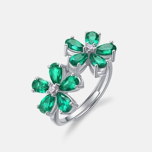 Elegant silver open ring featuring emerald pear-cut stones in a double floral design
