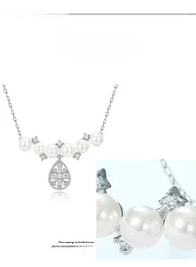 Detail of S925 silver snowflake pendant with gemstones and white shell pearls