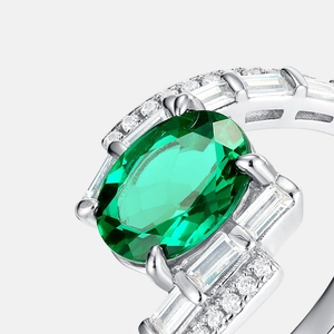 Luxurious S925 silver ring featuring oval emerald gemstone with diamond side stones