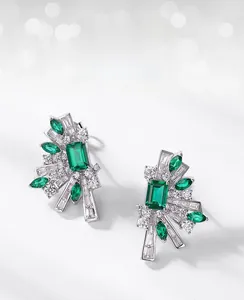 Detailed macro view of S925 silver emerald earrings with radial marquise cut stones