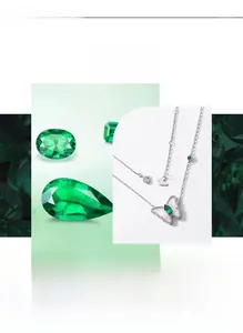 Detail of butterfly necklace with pear-cut emerald and sparkling pavé diamond wings