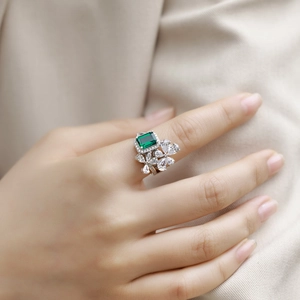 Elegant S925 silver emerald cut ring with pear-shaped cubic zirconia worn by model