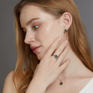 Close-up of S925 silver jewelry set with moss agate stones on a female model