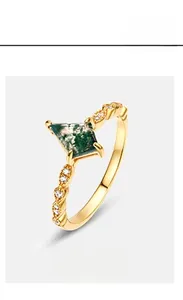Detailed macro view of kite-cut moss agate ring in gold-plated lace-edge vintage setting