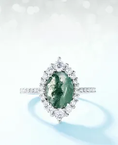 Detailed view of an oval moss agate ring with a halo of white zircons in S925 silver