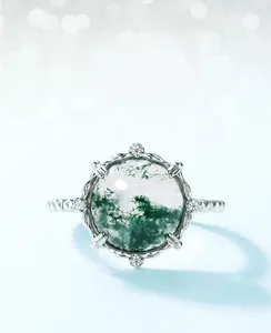 Macro shot of green moss agate ring with sterling silver setting and zircon halo