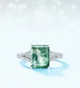 Macro shot of rectangular moss agate ring with side diamonds on S925 silver band