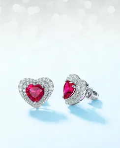 Detailed macro view of S925 silver heart stud earrings with red corundum and pavé zircon