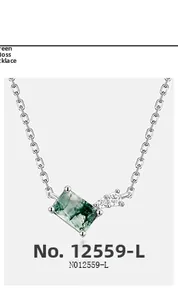 Macro view of green moss agate pendant with diamonds on a silver chain necklace